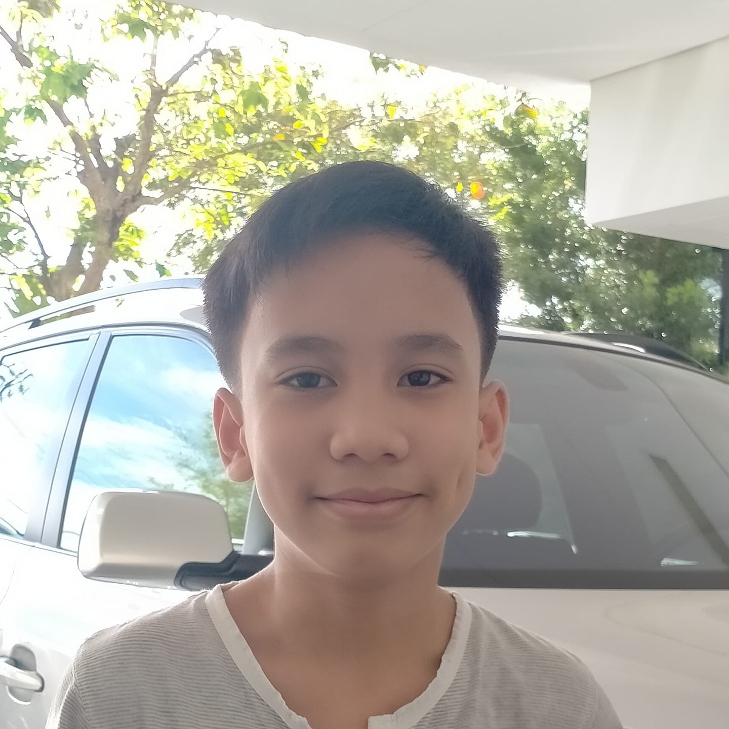 A young boy with his little sister taking a picture together