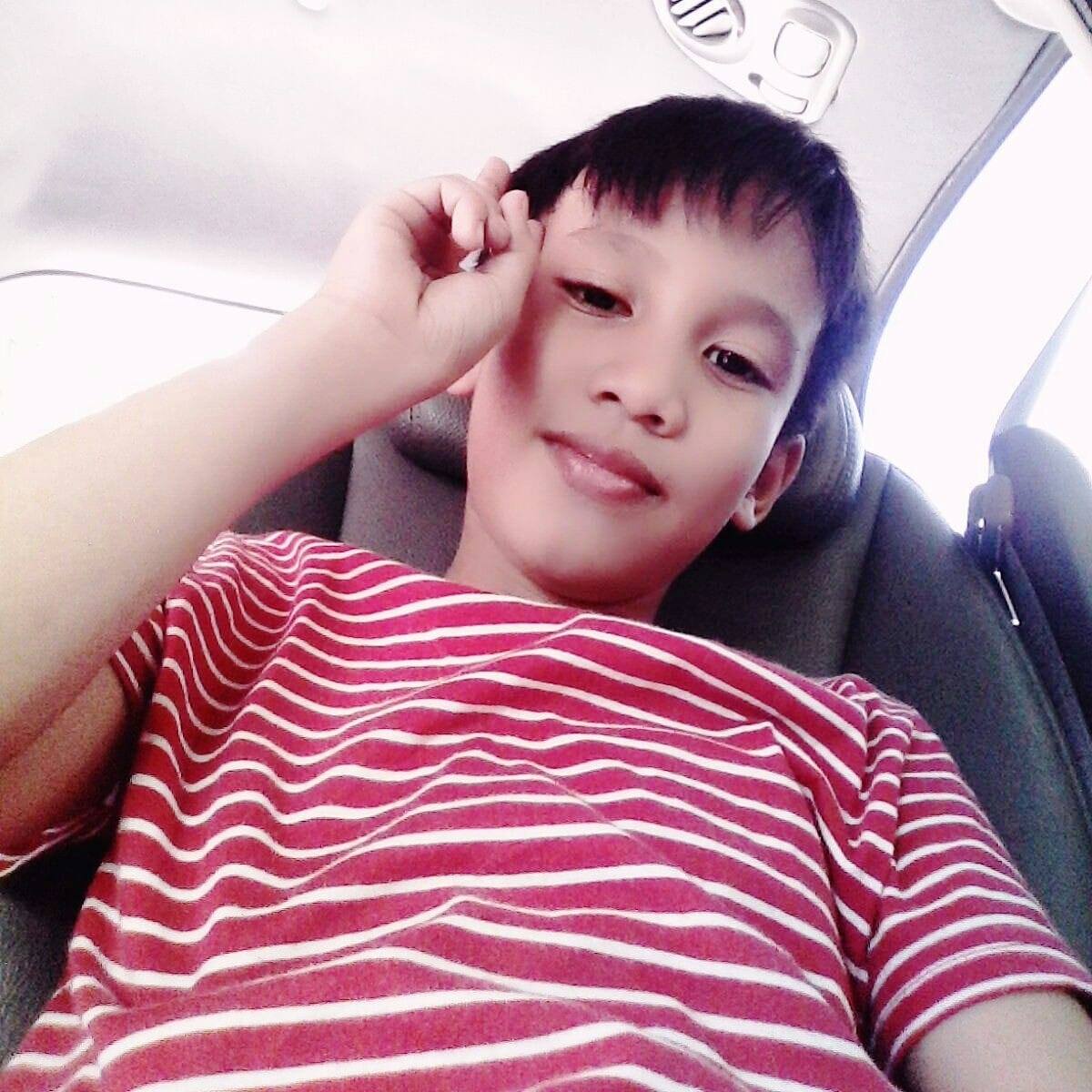 A young boy with his little sister taking a picture together